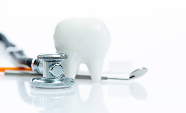 Stethoscope and dentist medical tools on white background.