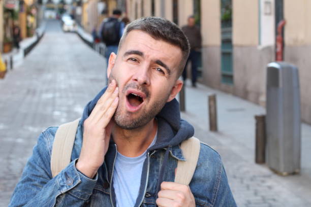 Unhappy man suffering from bruxism.